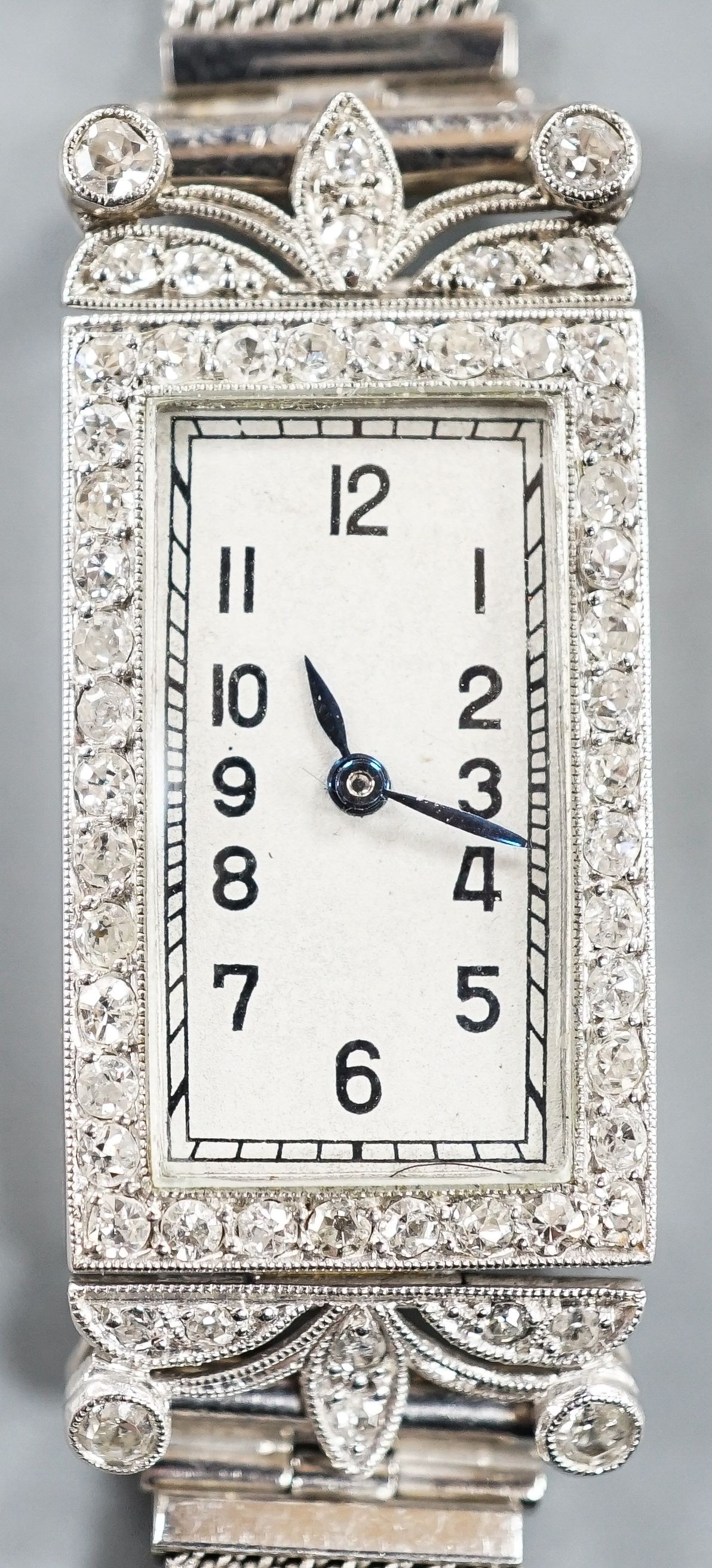 A lady's early 1970's white metal and diamond set cocktail watch (engraved Platine), on a 9ct white gold bracelet, case diameter 16mm, gross weight 21.4 grams.